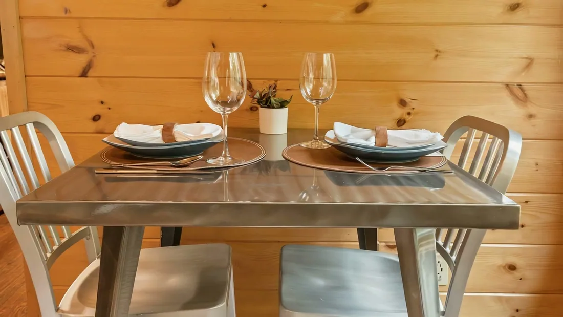 The Modern Pine's dining table set for two by the picture window